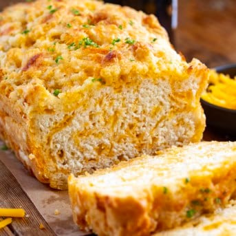 Loaf of Beer Cheese Bread with a few slices cut off.