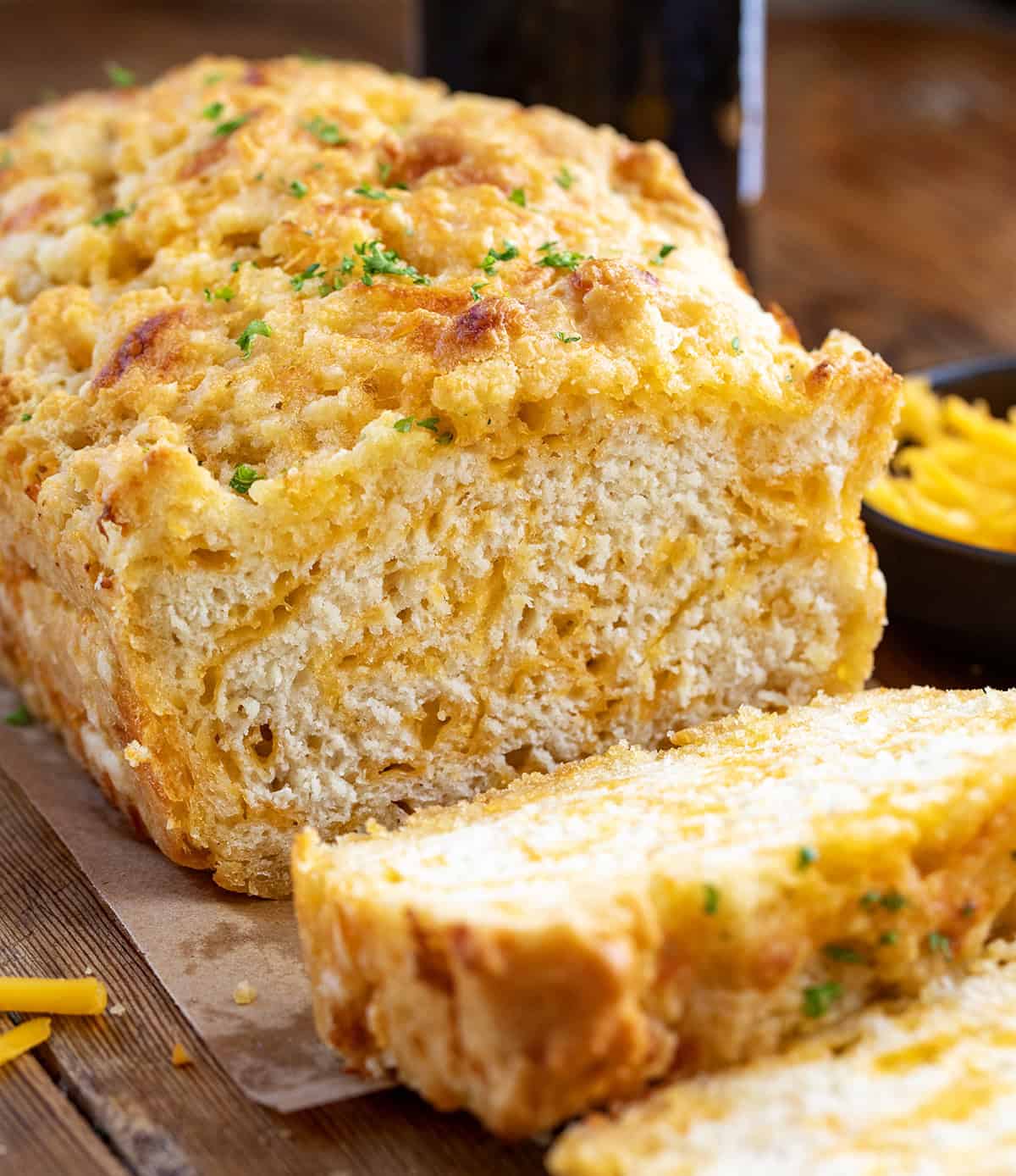 Loaf of Beer Cheese Bread with a few slices cut off.