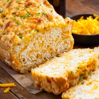 Loaf of Beer Cheese Bread with a few slices cut off.