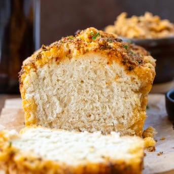 Loaf of Cowboy Butter Beer Bread that has been cut showing tender bread inside.