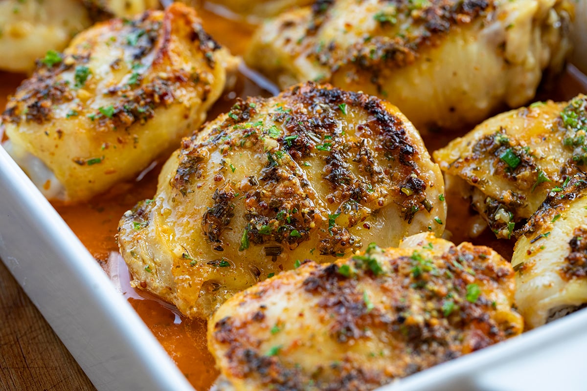 Close up of Cowboy Butter Chicken Thighs in a baking dish.