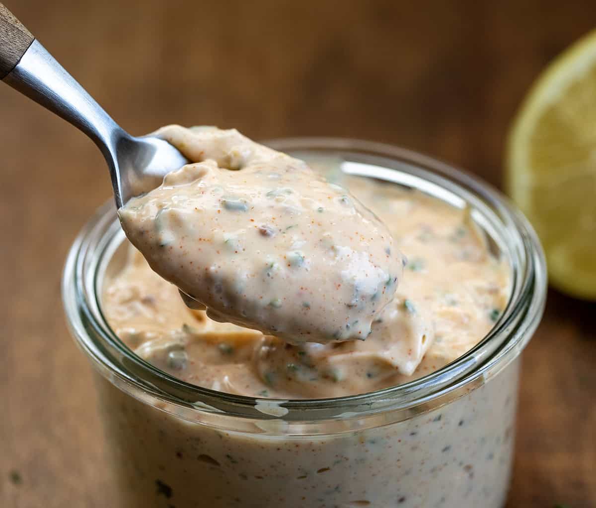 Spoonful of Cowboy Mayo being held above the jar.
