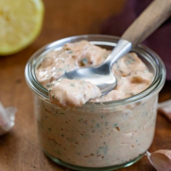 Jar of Cowboy Mayo with a spoon on top with mayo on it.