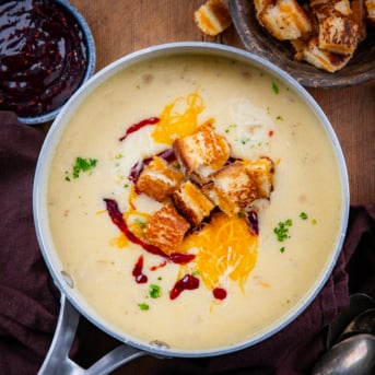 Monte Cristo Soup in a pot on a wooden table from overhead.