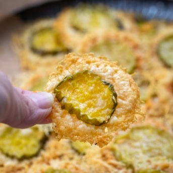 Hand holding a Parmesan Pickle Crisp.