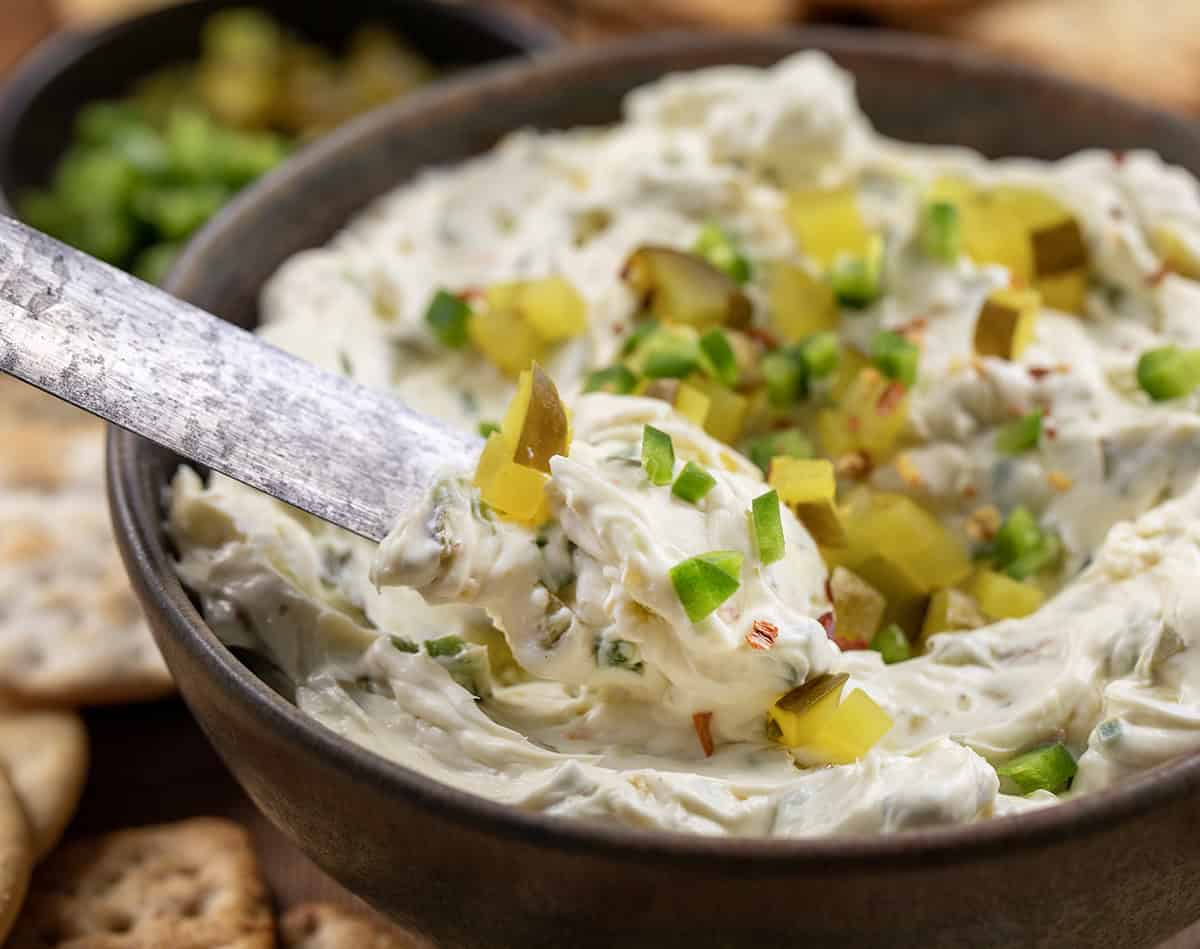 Knife scooping up Spicy Dill Pickle Dip from bowl.