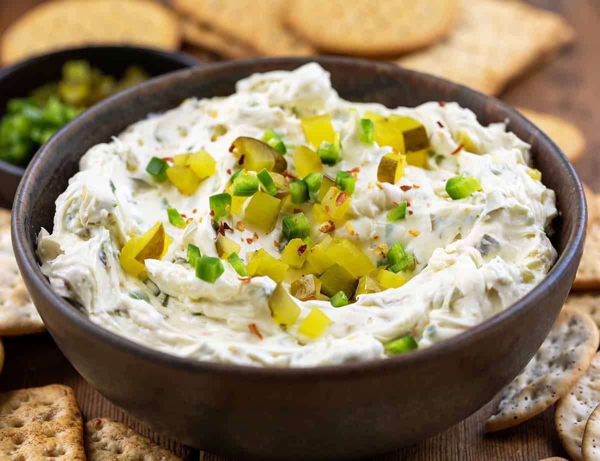 Bowl of Spicy Dill Pickle Dip surrounded by crackers.