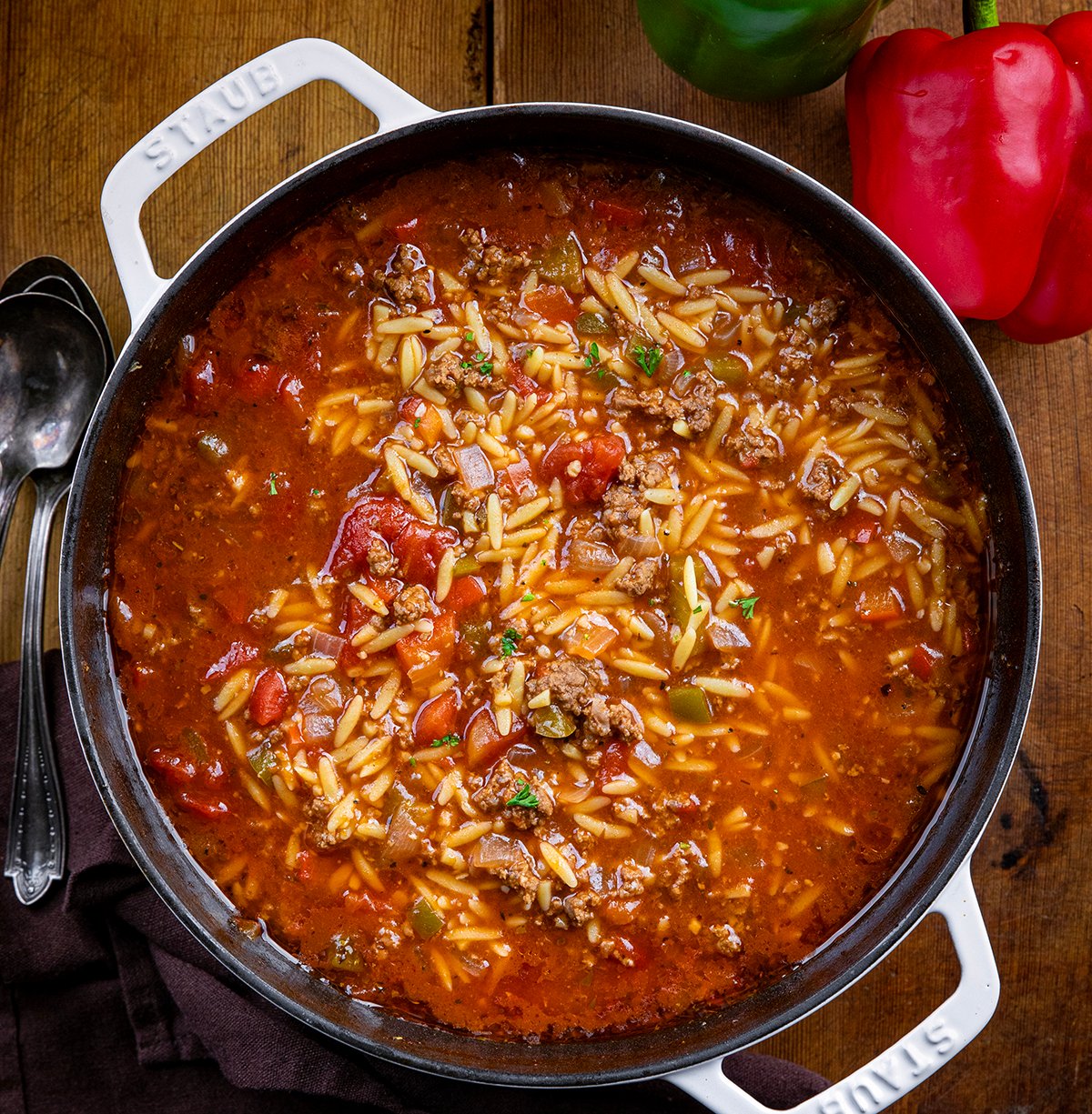 Pot of Stuffed Pepper Orzo Soup on a wooden table from overhead.