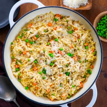Pan of Chicken Pot Pie Orzo on a wooden table from overhead.