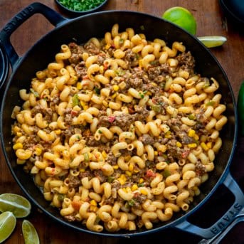 Skillet of Cowboy Cavatappi on a wooden table from overhead.