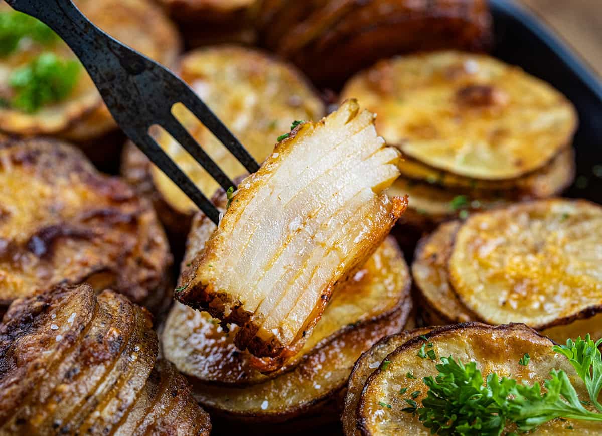 Cut into stack of Crispy Potato Stacks on a fork.