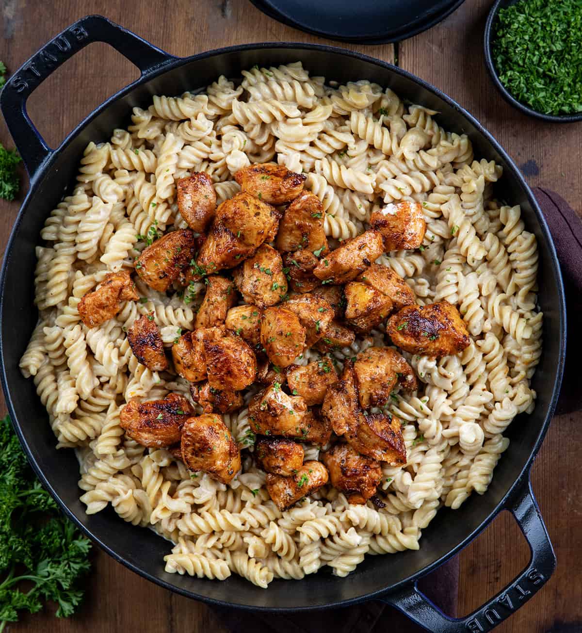 Skillet filled with Garlic Chicken Rotini with the crispy chicken sitting on top of the pasta from overhead.