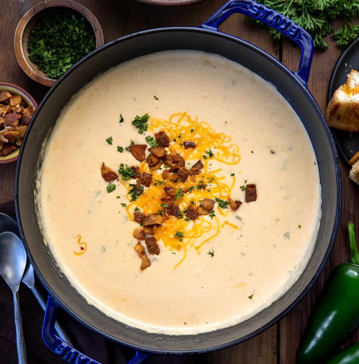 Pot of Jalapeño Popper Soup on a wooden table from overhead.