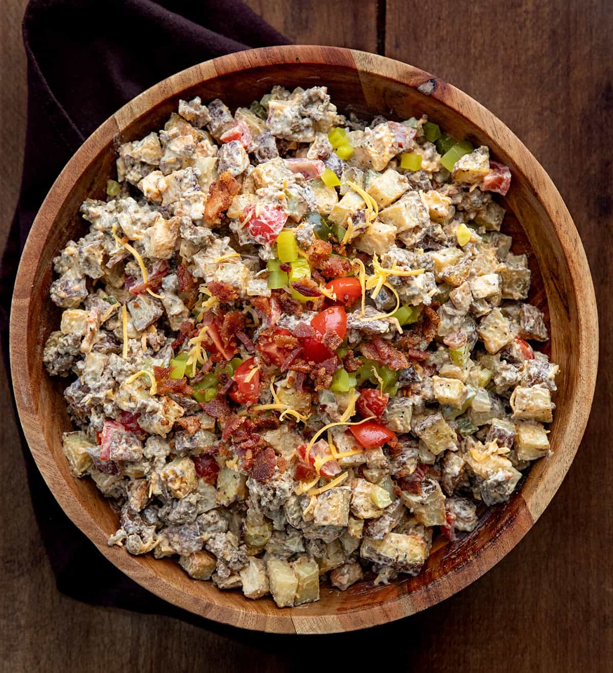 Cheeseburger Bowl on a wooden table from overhead.