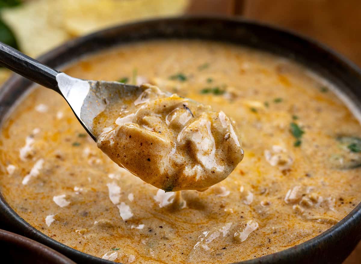 Spoonful of Chipotle Chicken Chili being held above the bowl.