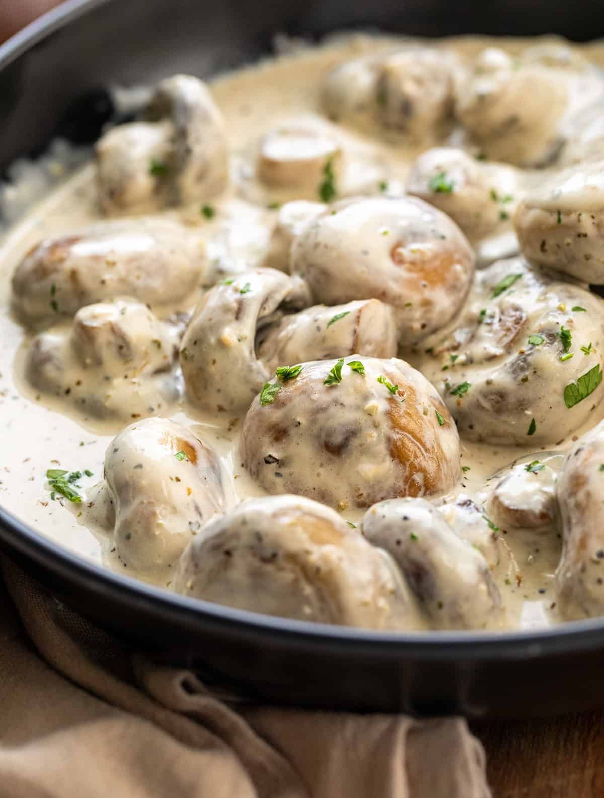 Close up of Creamy Garlic Parmesan Mushrooms in a pan.