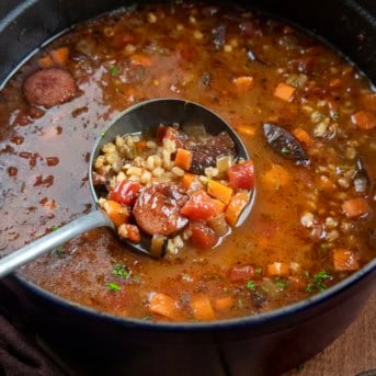 Ladle in a pot of Kielbasa Barley Soup.