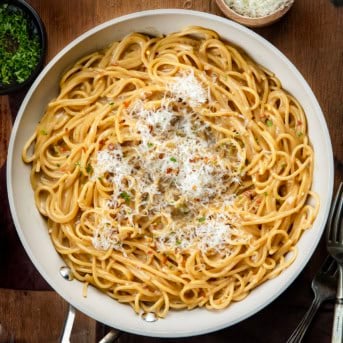 Skillet of Sticky Honey Garlic Pasta on a wooden table from overhead.