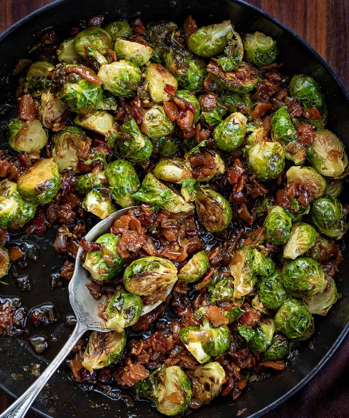 Pan of Bacon Jam Brussels Sprouts with a spoon resting in the pan.