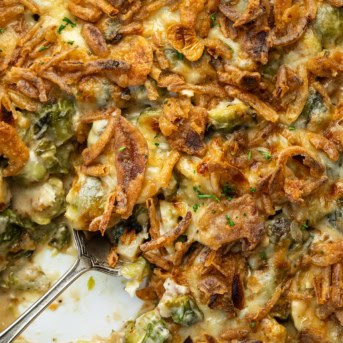 Close up of a spoon in Cheesy Brussels Sprout Casserole.