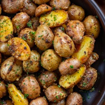 Close up of Cowboy Mayo Roasted Potatoes in a wooden bowl.