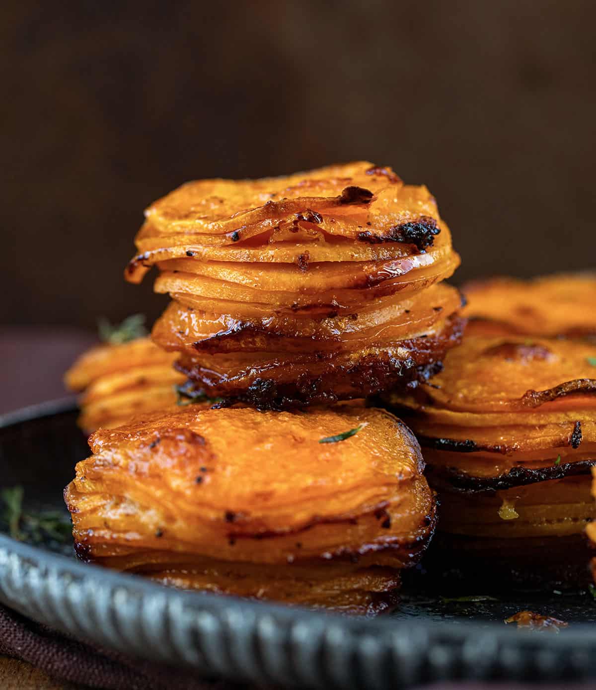 Crispy Sweet Potato Stacks on a platter on a wooden table close up.