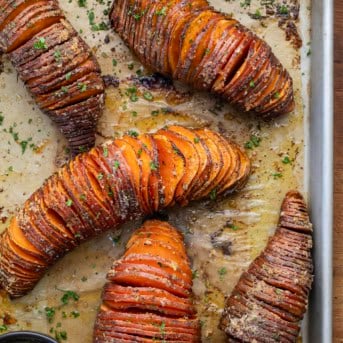 Hasselback Sweet Potatoes on a sheet pan from overhead.