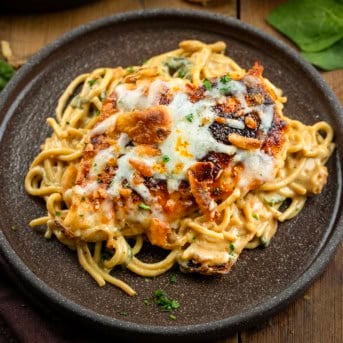 Plate of Monterey Chicken Spaghetti on a wooden table.