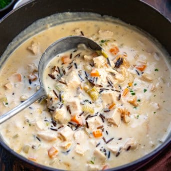 Scooping up Turkey Wild Rice Soup from the pot.