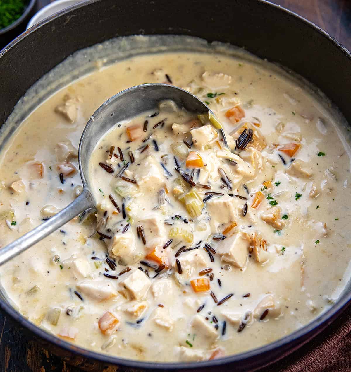 Scooping up Turkey Wild Rice Soup from the pot.