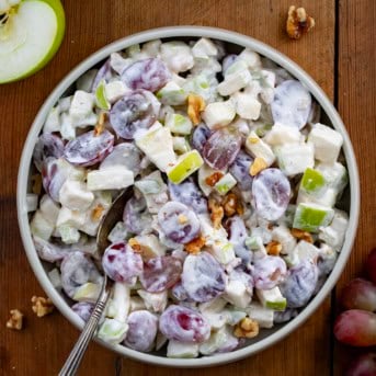 Bowl of Waldorf Salad on a wooden table from overhead.