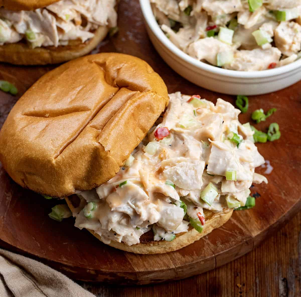 This Bang Bang Chicken Salad is creamy, slightly spicy, and ready in just minutes, perfect for a quick lunch, light dinner, or game-day spread! Bang Bang Chicken Salad sandwich with the top bun askew.