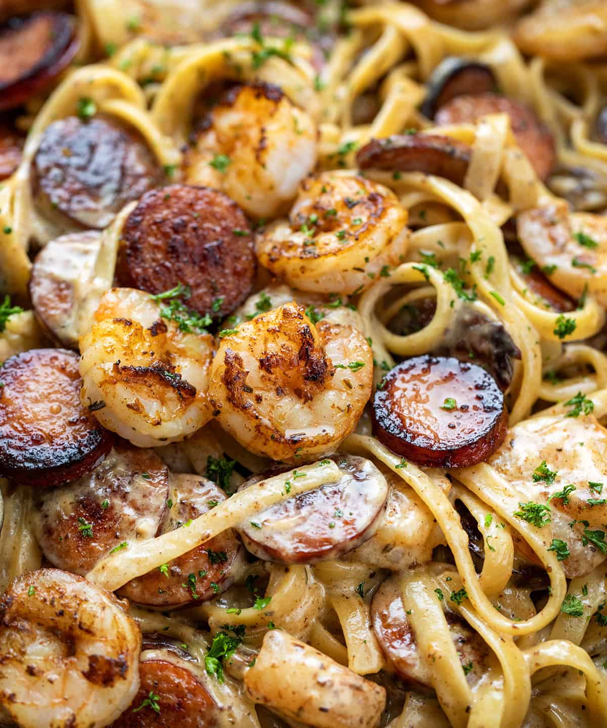 Try this Cajun Shrimp and Sausage Pasta for a spicy, creamy meal. It combines shrimp, sausage, and fettuccine in under 30 minutes! Close up of Cajun Shrimp and Sausage Pasta.