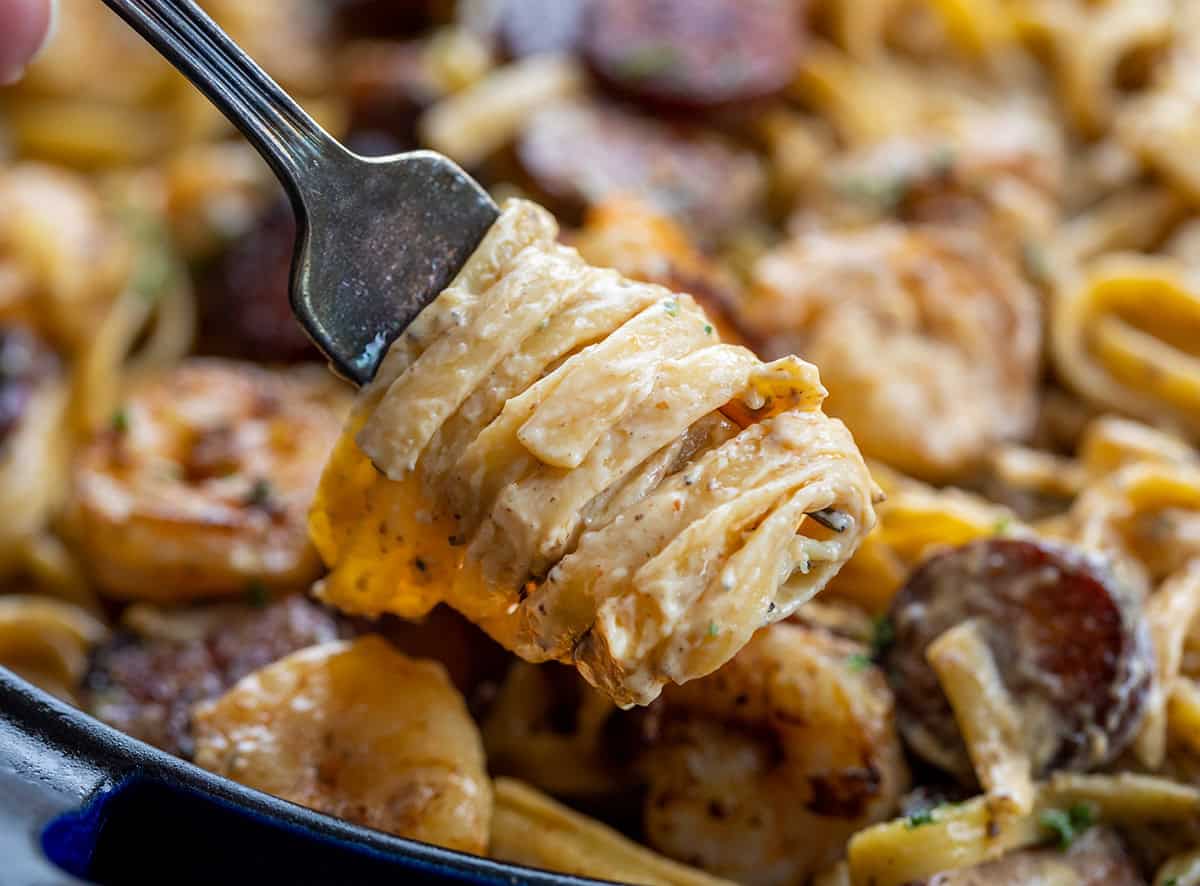 Try this Cajun Shrimp and Sausage Pasta for a spicy, creamy meal. It combines shrimp, sausage, and fettuccine in under 30 minutes! Creamy pasta twirled around a fork close up.