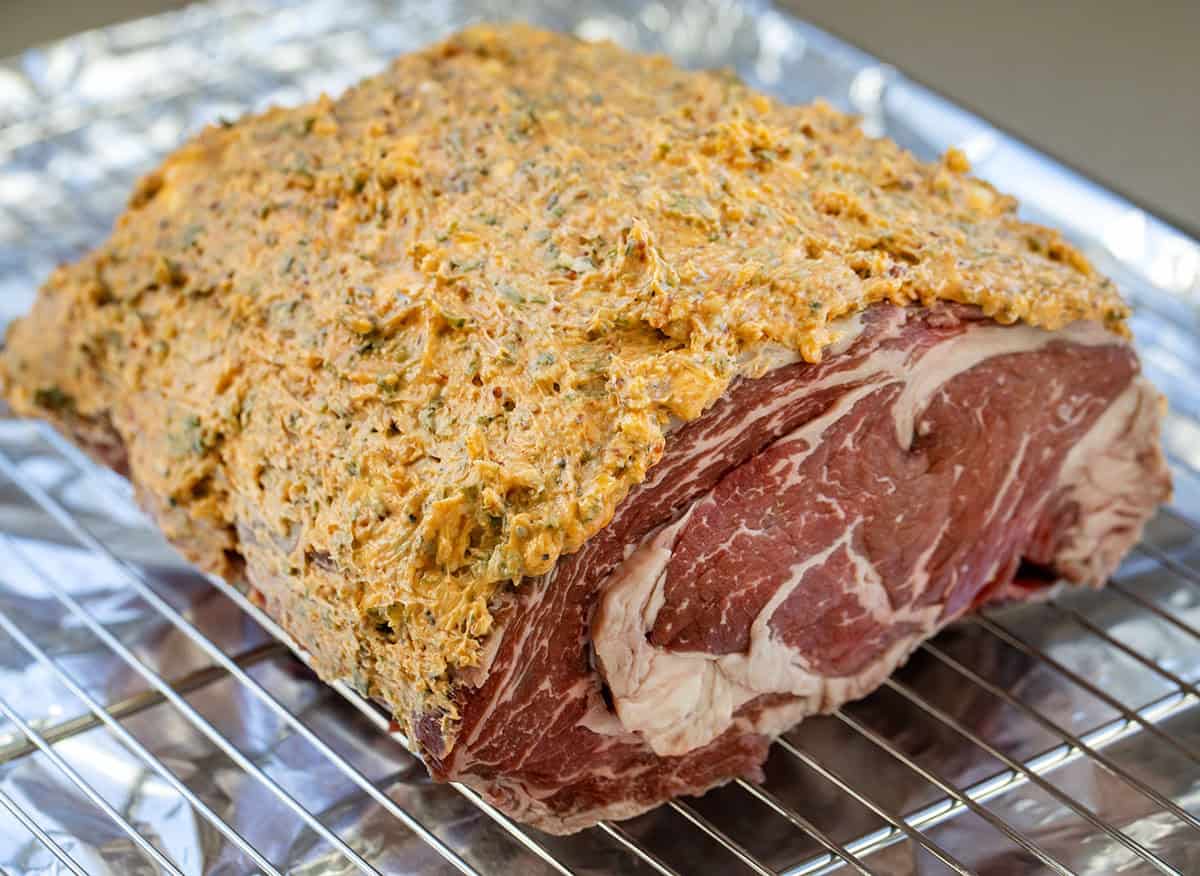 All the flavor of my popular Prime Rib gets an extra punch with my homemade Cowboy Butter! This prime rib is perfectly roasted, with a golden, flavorful crust, and each juicy slice is topped with a spicy, herby butter that melts into the meat! Cowboy Butter coating on a rib roast to make Cowboy Butter Prime Rib.