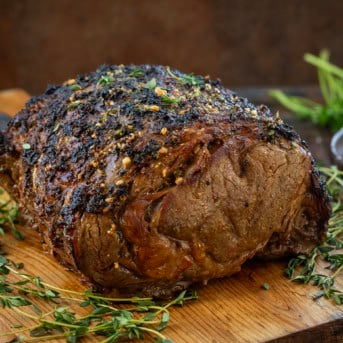 Whole Cowboy Butter Prime Rib on a wooden cutting board.