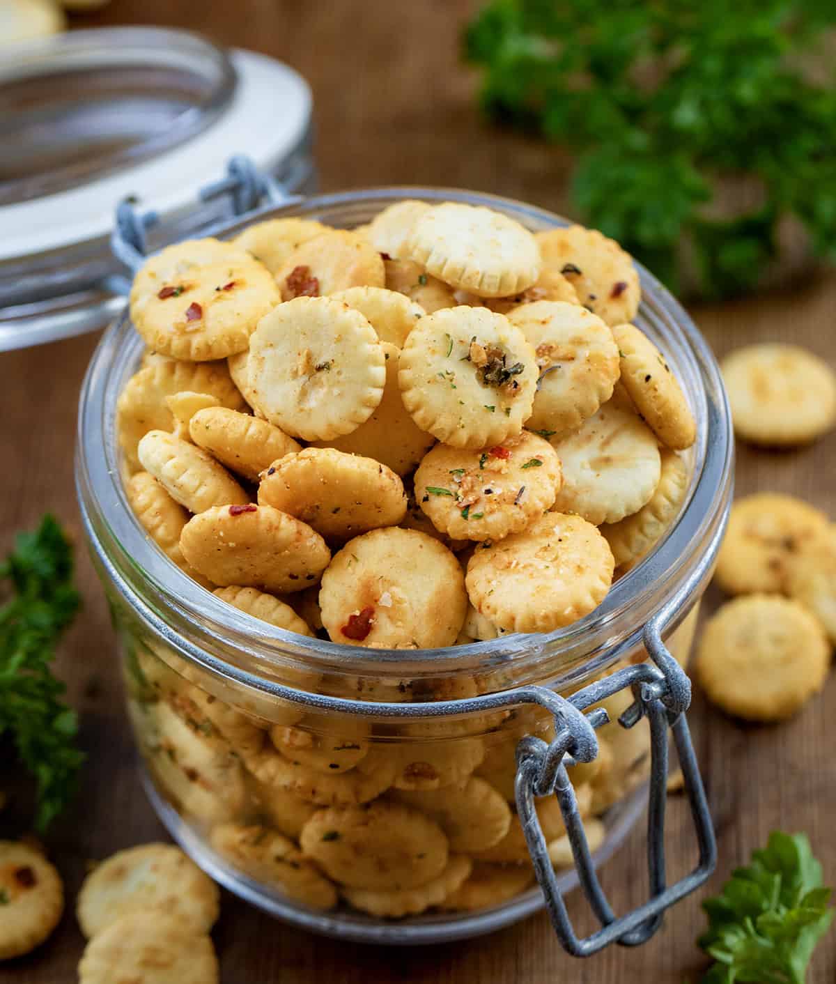 If you’re looking for a quick, flavorful snack that’s perfect for game day, parties, or just munching on while watching your favorite show, these Cowboy Butter Oyster Crackers are exactly what you need. Coated in my signature Cowboy Butter seasoning mix, they’re buttery, savory, and packed with bold flavor! Jar of Cowboy Butter Oyster Crackers on a wooden table.