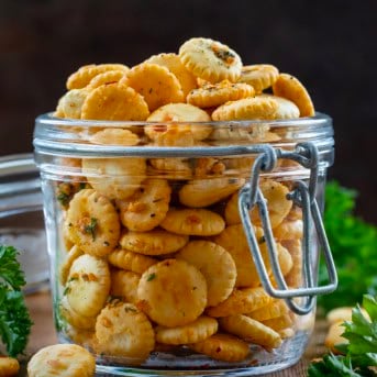 Close up of a jar of Cowboy Butter Oyster Crackers on a wooden table.