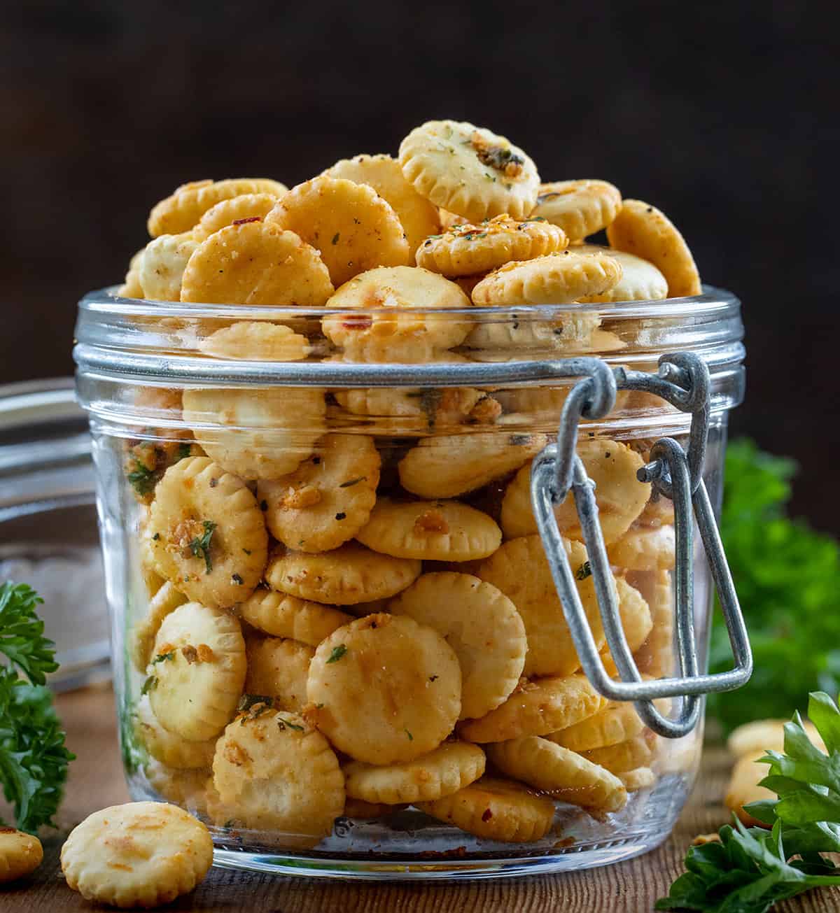 If you’re looking for a quick, flavorful snack that’s perfect for game day, parties, or just munching on while watching your favorite show, these Cowboy Butter Oyster Crackers are exactly what you need. Coated in my signature Cowboy Butter seasoning mix, they’re buttery, savory, and packed with bold flavor! Close up of a jar of Cowboy Butter Oyster Crackers on a wooden table.