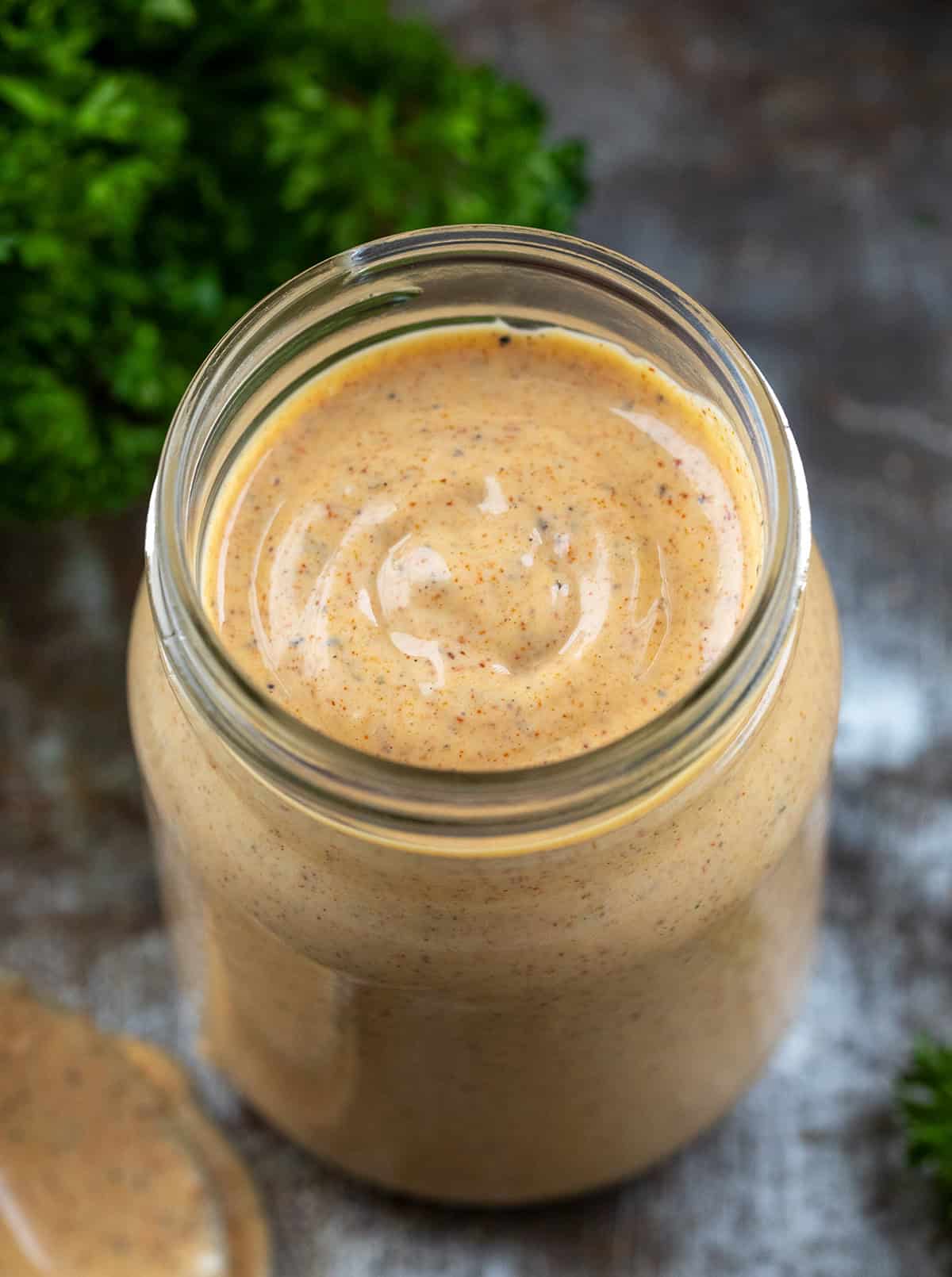 If you’ve ever dipped wings into the Southwest Ranch at Buffalo Wild Wings, you know how good that creamy-zesty combo is. This homemade version tastes just as delicious, if not better! Looking down into a jar of Southwest Ranch Sauce.