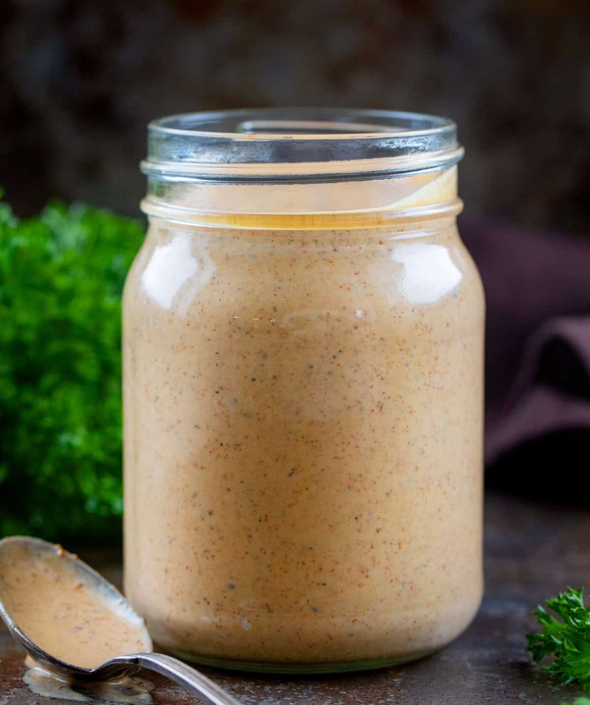 If you’ve ever dipped wings into the Southwest Ranch at Buffalo Wild Wings, you know how good that creamy-zesty combo is. This homemade version tastes just as delicious, if not better! Jar of Southwest Ranch Sauce with a spoon next to it.