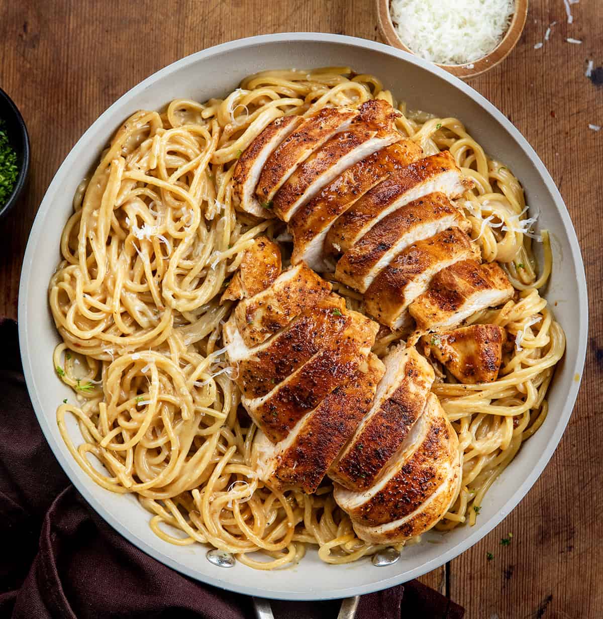 Pan of Sticky Honey Garlic Chicken Pasta on a wooden table from overhead.