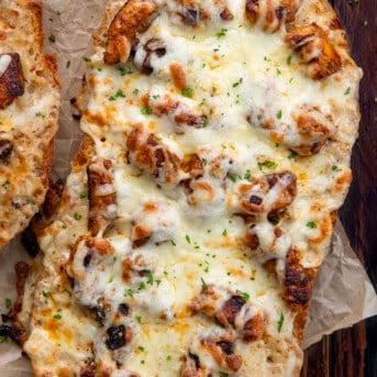 Close up of half of Blackened Chicken Alfredo Garlic Bread.