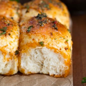 Close up of a Cowboy Butter Dinner Roll that has been separated and shows the tender dough.