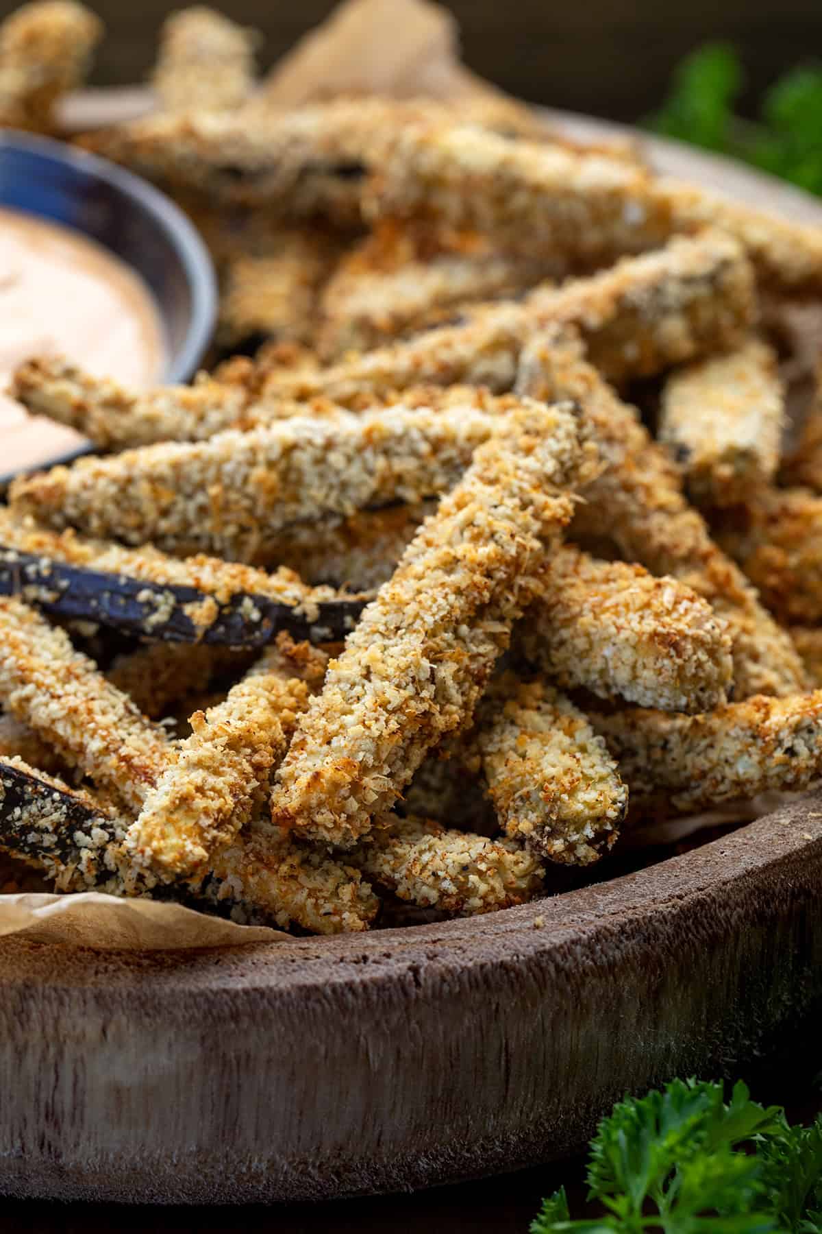 Crispy, golden, and totally snack-worthy, these Eggplant Fries are about to change how you feel about eggplant! Seriously, you have to give them a try. They’re coated in a crunchy Parmesan-panko crust, baked (or air-fried!), and served with a smoky chipotle aioli that’s perfect for dipping! Close up of Eggplant Fries in a wooden bowl.