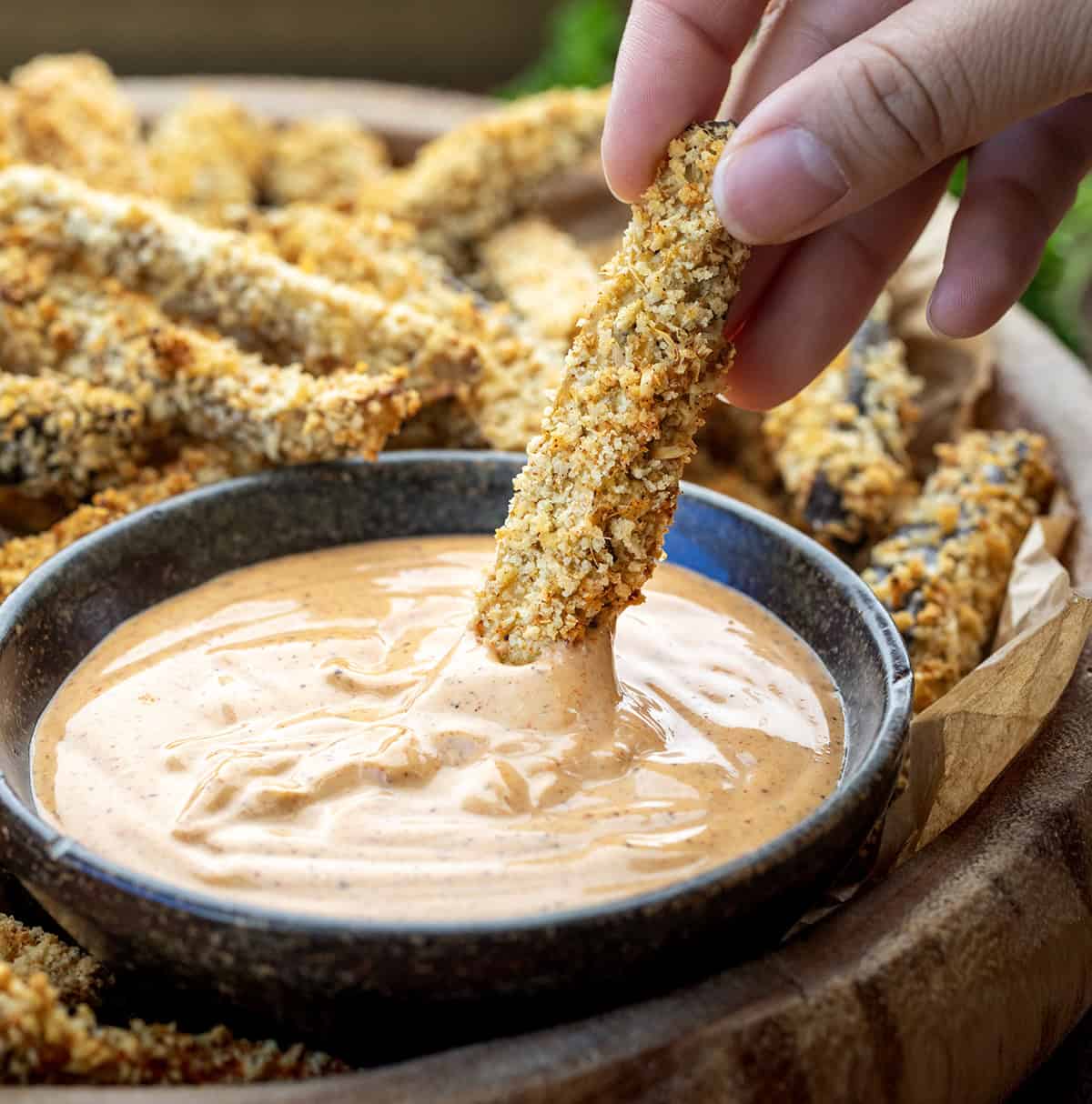Crispy, golden, and totally snack-worthy, these Eggplant Fries are about to change how you feel about eggplant! Seriously, you have to give them a try. They’re coated in a crunchy Parmesan-panko crust, baked (or air-fried!), and served with a smoky chipotle aioli that’s perfect for dipping! Dipping an Eggplant Fry into chipotle aioli sauce.