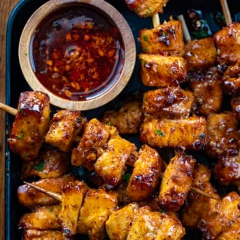 Close up of Garlic Chili oil and Garlic Chili Chicken Skewers in a pan.