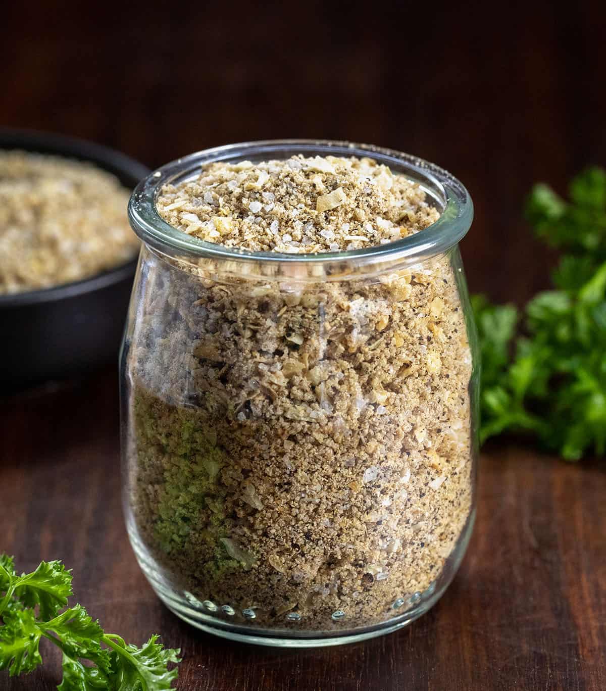 Homemade Sloppy Joe Dry Mix is a simple, pantry-friendly mix that you can whip up in minutes and keep on hand for months. Just a few tablespoons of this mix and ground beef turns into rich, savory, slightly sweet Sloppy Joes that everyone will love! Jar of Homemade Sloppy Joe Dry Mix on a wooden table.