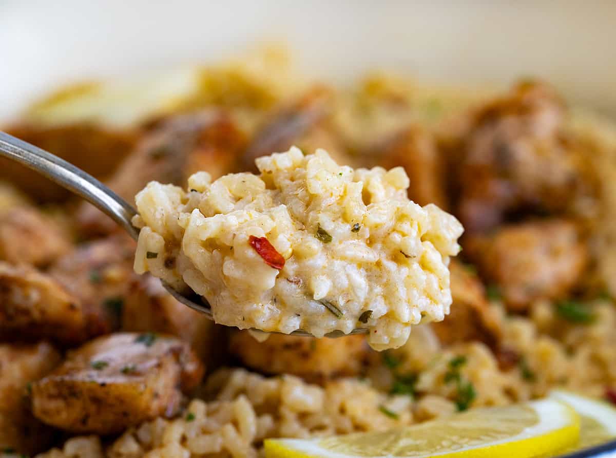 Tender chicken in a rich, buttery cowboy butter sauce served over fluffy rice. This flavorful dinner is easy to make and comes together quickly, perfect for weeknights or a cozy weekend meal! Spoonful of creamy rice from Cowboy Butter Chicken and Rice.