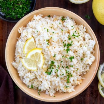 Bowl of Lemon Rice on a wooden table from overhead.